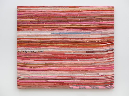 Many fabric strips in various shades of red
